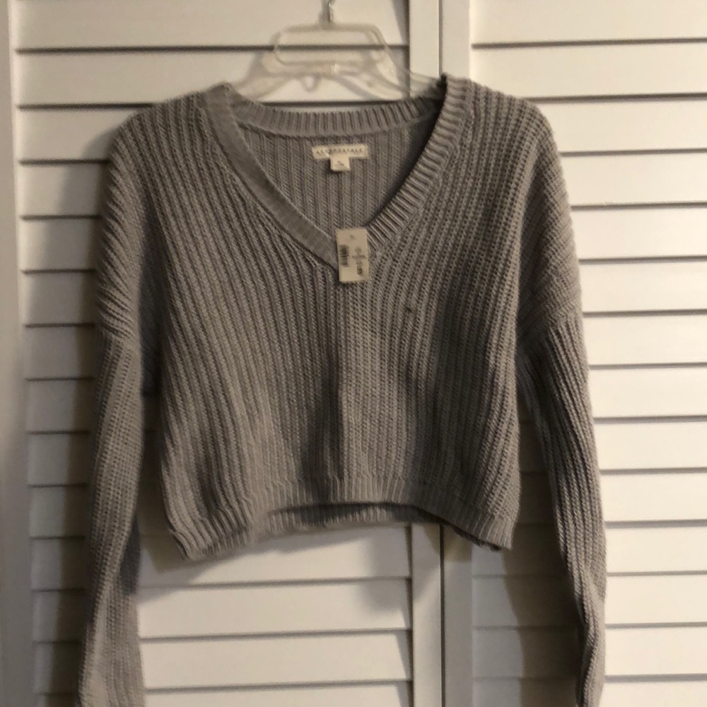 New, tags attached gray v-neck sweater